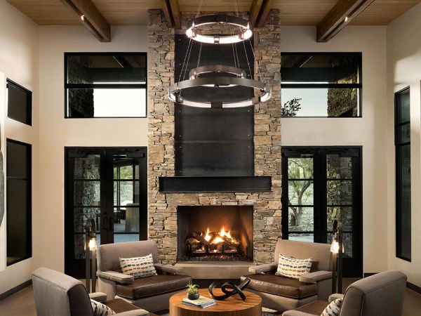 Living room with fireplace and stone wall